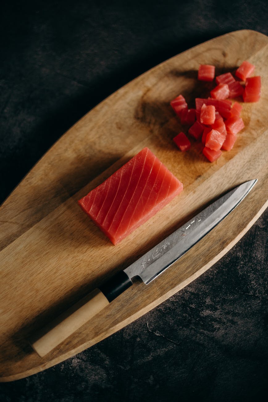 sliced strawberry on brown wooden chopping board